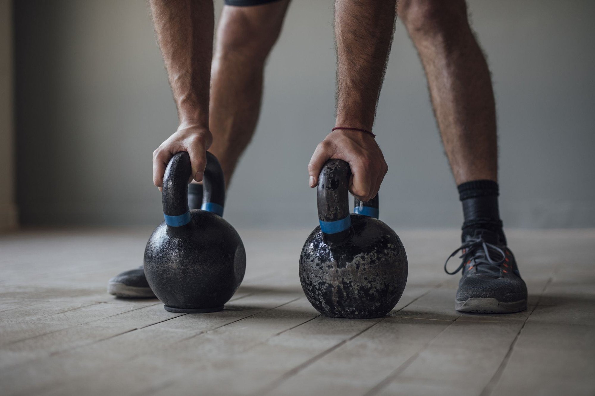 unrecognizable-man-exercising-with-kettlebells-royalty-free-image-1641297939